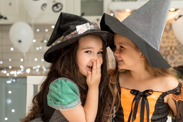 Front view of cute little girls with witch costume