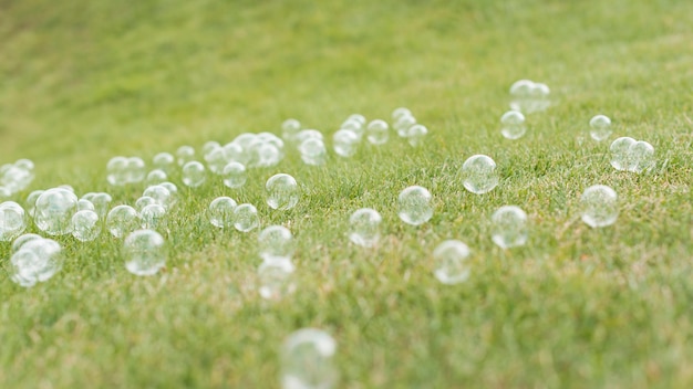 Front view cute soap bubbles on grass