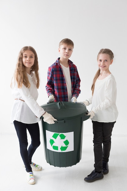 Front view cute young children happy to recycle