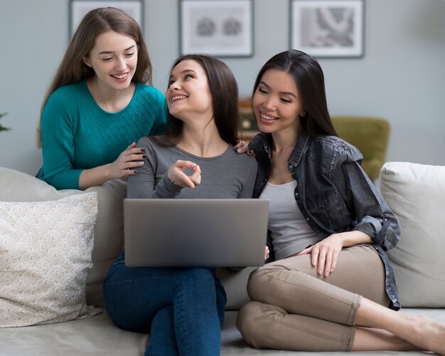 Front view cute young women together at home