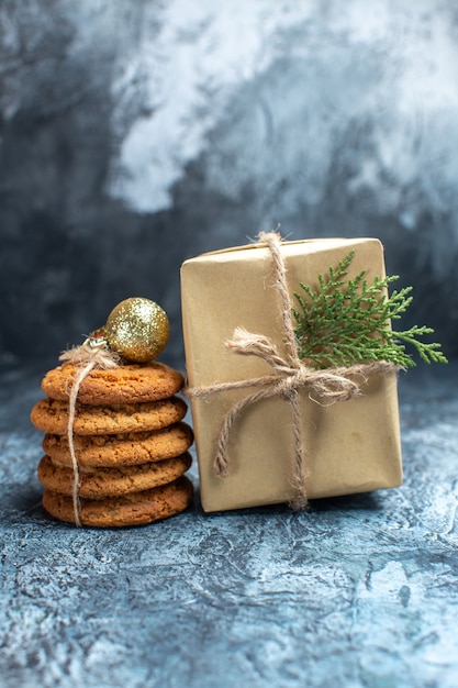 Front view delicious biscuits with present on light desk