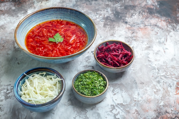 Free Photo front view delicious borsch ukrainian beet soup with fresh cabbage and greens on a white table