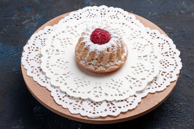 Front view delicious cake with cream and red raspberry on the dark surface cake fruit biscuit 