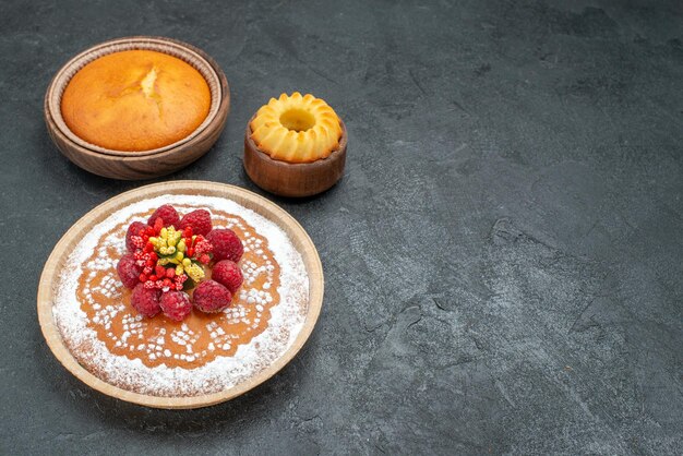 Front view delicious cake with sugar powder and raspberries on grey background cake pie fruit berry sweet cookie