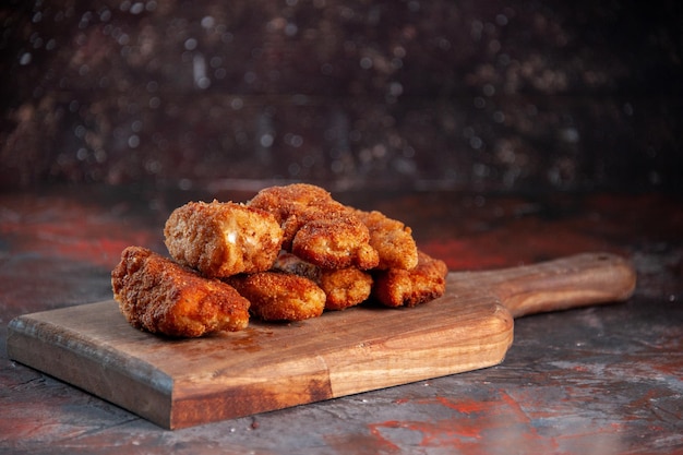 Free photo front view delicious chicken wings on cutting board dark background meal dinner food fries sandwich lunch meat color