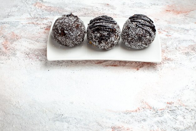 Front view delicious chocolate cakes with icing on light-white surface chocolate sugar biscuit sweet cake bake cookies