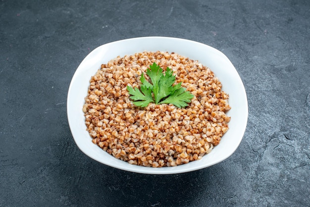 Free photo front view delicious cooked buckwheat useful meal inside plate on dark space