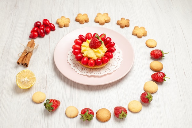 Front view delicious cookies with fruits and cake on white desk fruit tea biscuit dessert