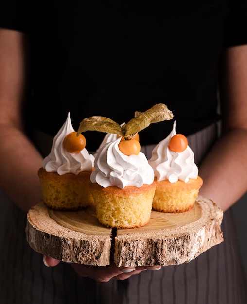 Front view of delicious cupcakes with icing