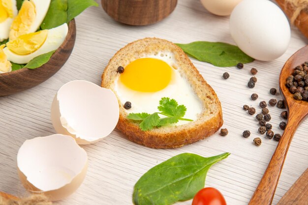 Front view delicious egg toasts with tomatoes and seasonings on white background photo morning meal breakfast lunch salad color food