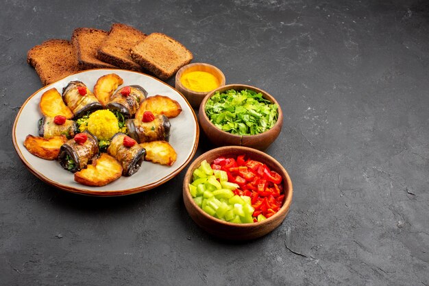 Front view delicious eggplant rolls cooked dish with baked potatoes and bread on dark background dish cooking food potato fry bake