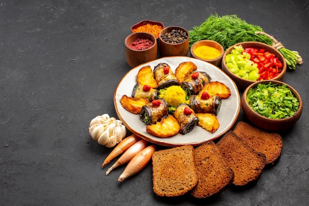 Front view delicious eggplant rolls cooked dish with potatoes and bread loafs on dark background cooking food dish bake fry potato