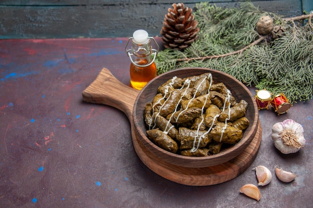 Front view delicious leaf dolma meat dish with seasonings on dark space