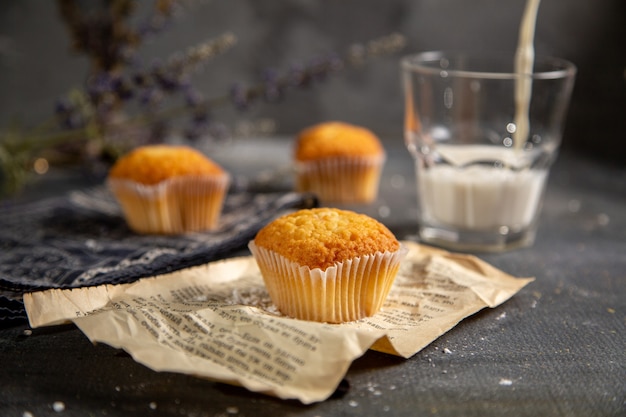 A front view delicious little cakes with purple flowers on the grey table cookie tea biscuit sweet