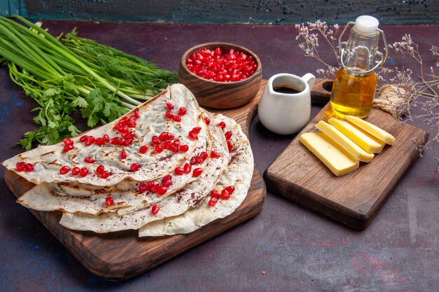 Front view delicious meat qutabs pitas with fresh red pomegranates on dark surface dough pita meal food meat