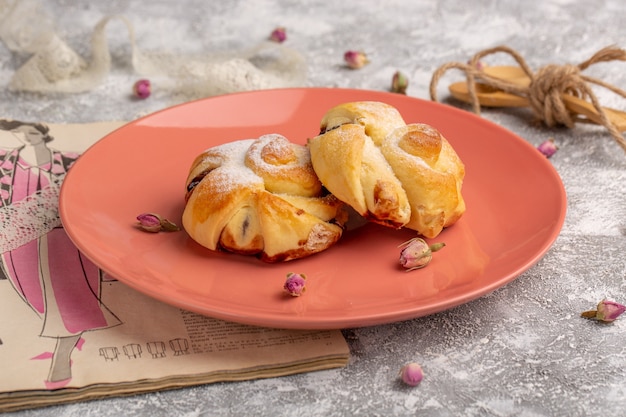 Front view delicious pastries with filling inside plate on the white table, sweet sugar cake bake pastry