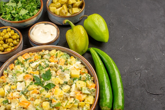 Free photo front view of delicious salad with ingredients on dark surface