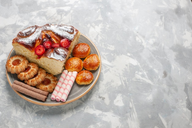 Free Photo front view delicious strawberry cake with cookies and little cakes on the white surface