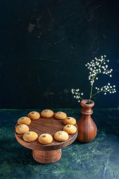 Front view delicious sweet biscuits on dark blue cookie sugar cake pie tea photo dessert