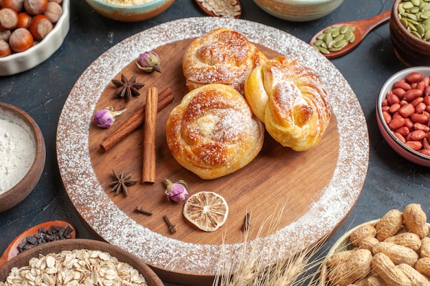 Free Photo front view delicious sweet buns with nuts on grey cake color sugar dough pie hotcake bake tea