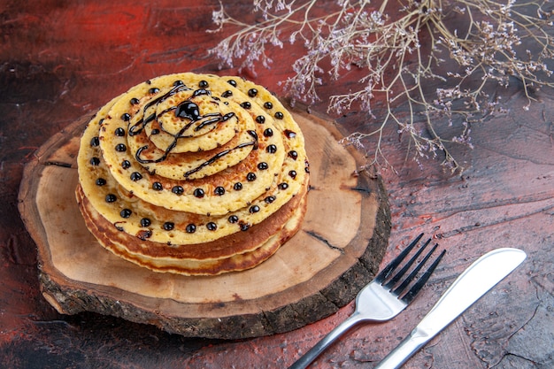 Front view delicious sweet pancakes with icing on a dark background