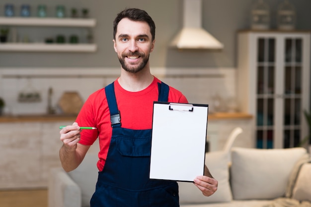 Front view of delivery man holding notepad for signature