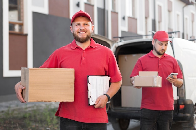 Free photo front view of delivery man with packagaes