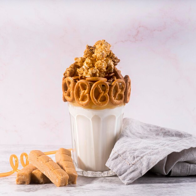 Front view of dessert in glass with pretzels and cloth