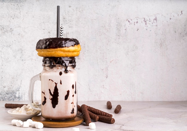 Free Photo front view of dessert in jar with donuts and marshmallows