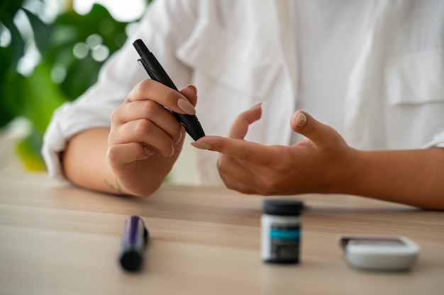 Free Photo front view diabetic woman checking her glucose level