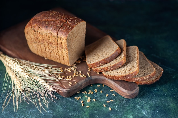 Free Photo front view of dietary black bread spikes on blue dark colors background