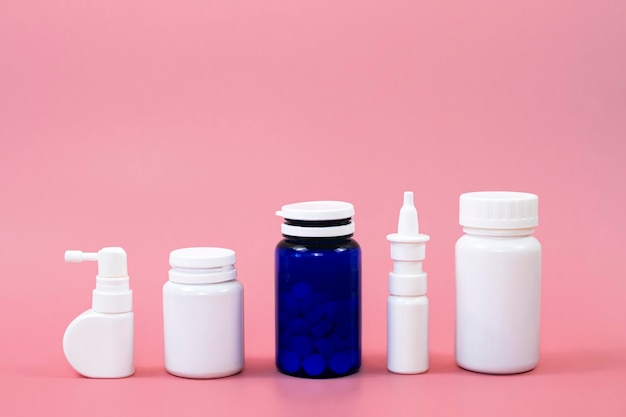 Front view of different pill containers with copy space