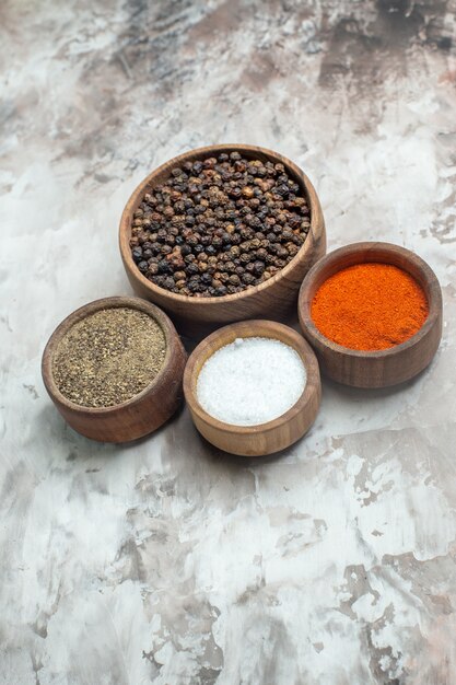 Front view different seasonings on a white table