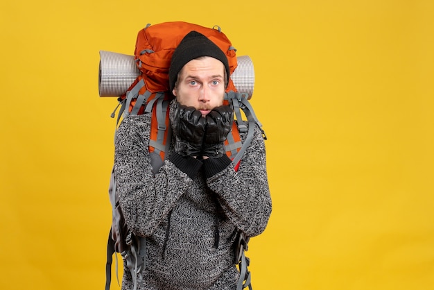 Free Photo front view of disappointed male hitchhiker with leather gloves and backpack