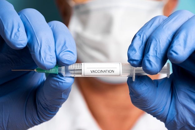 Free Photo front view doctor holding vaccine