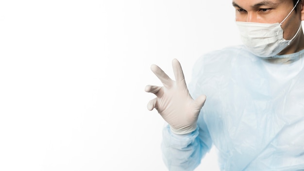 Front view of doctor with surgical gloves and medical mask