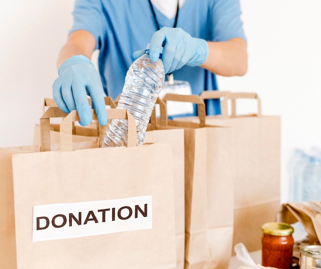 Free photo front view of donation bags being prepared with provisions