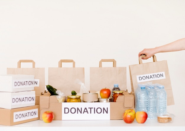 Free photo front view of donation boxes and bags with food