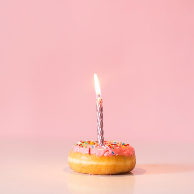 Free photo front view donut with lit candle