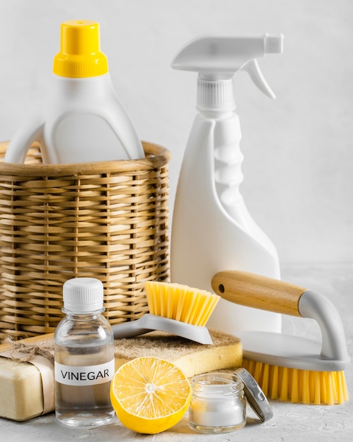 Free photo front view of eco-friendly cleaning brushes in basket with lemon and vinegar