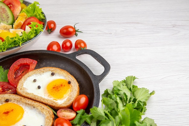 Free photo front view egg toasts with tomatoes and salad on white background breakfast lunch food meal color salad