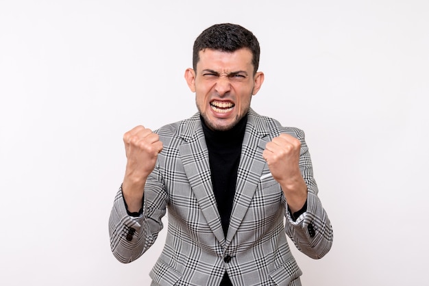 Front view elated handsome male in suit showing winning gesture standing on white background