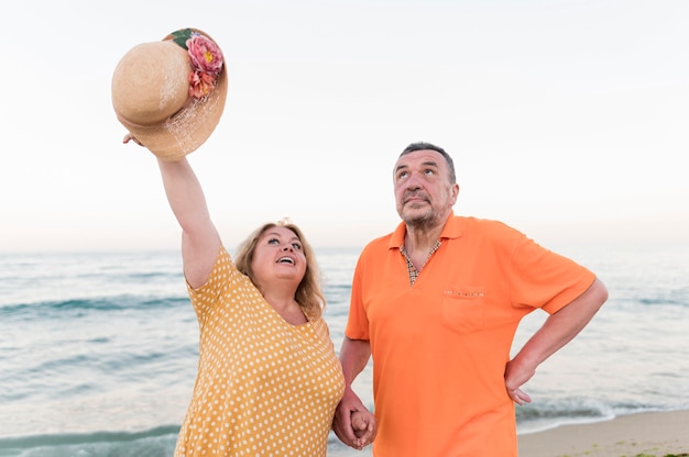 Front view of elder tourist couple at the beach