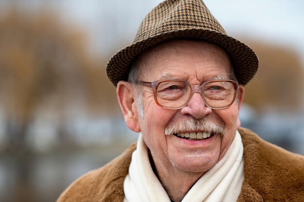 Free Photo front view elderly man wearing hat