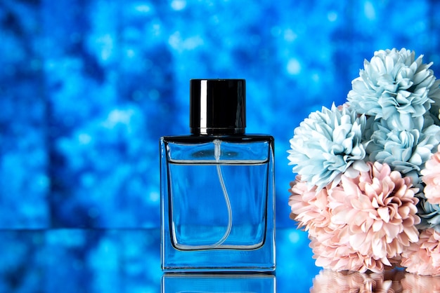 Front view of elegant women perfume colored flowers on blue blurred background