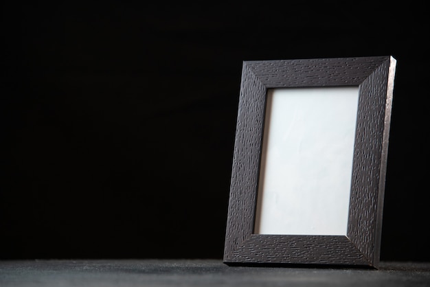 Front view of empty picture frame on dark