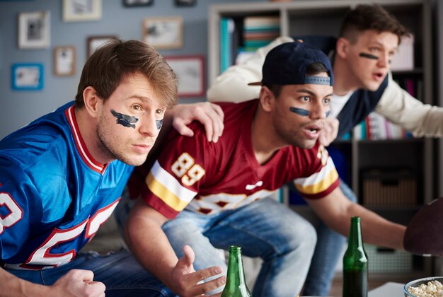 Front view of excited men watching sports game