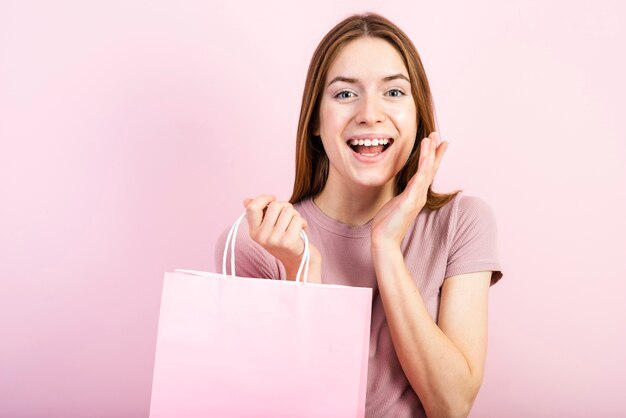 Front view excited woman with pink background