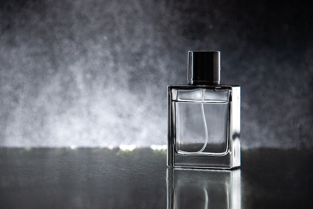 Free photo front view expensive perfume as a present on the dark table