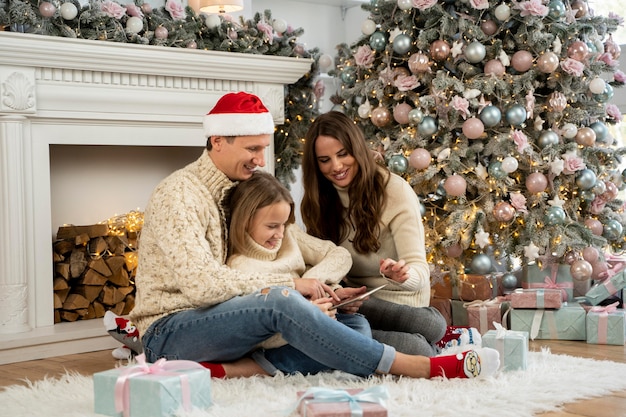 Front view of family and christmas tree